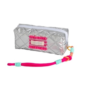High-capacity silver quilted stationery pouch with pink ruffle detail and colorful lanyard