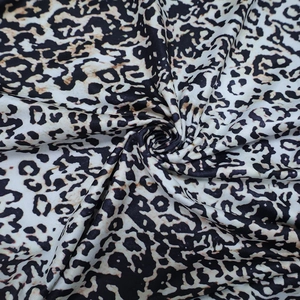 Close-up of leopard print fabric detail with monochrome tones and soft texture