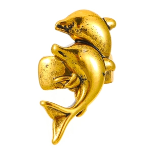 Macro shot of gold dolphin ear cuff with vintage texture on white background