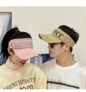 Detail view of pink and beige knitted sun visors with SPORT embroidery on models