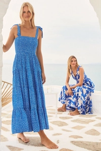 Detail of elegant backless summer dress with blue floral print and lace-up straps