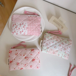 Quilted floral cotton coin purses with zippers and simple wish labels on a soft desk