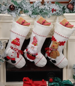 Detail of three white Christmas stockings with 3D Santa, Snowman and Reindeer characters