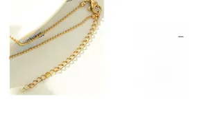 Detailed close-up of 18K gold-plated double-layer bead chain with adjustable clasp