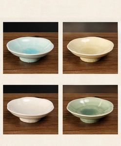 Detail view of four ceramic tea plates with ice crackle glaze in various vintage colors