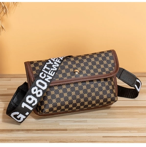 Detailed view of a brown vintage patterned crossbody bag with a wide fabric shoulder strap