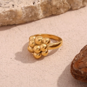 Detailed macro view of gold bubble cluster ring featuring stacked spherical elements