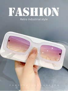 Detail view of retro white translucent rectangular sunglasses with purple gradient lenses
