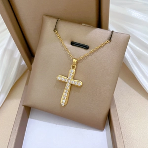 Golden cross necklace with sparkling cubic zirconia displayed in a premium gift box