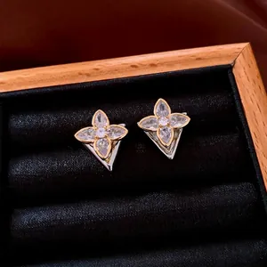 Elegant gold and silver flower stud earrings with sparkling cubic zirconia crystals