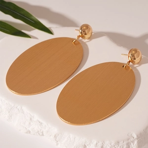 Statement large golden oval geometric drop earrings with a brushed metal texture finish