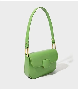 Detail of light green PU leather shoulder bag with square buckle and gold metal hardware
