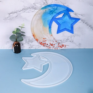 Macro detail of moon and star silicone mold with a resin gradient tray and gold flakes