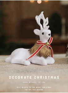 Close-up of white plush Christmas reindeer with red ribbon and golden bell decoration