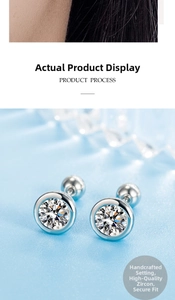Detail view of round zircon stud earring with screw back on light blue silk background