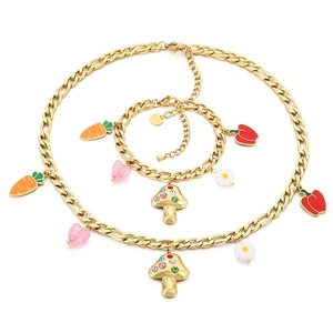 Gold Figaro chain set with mushroom, carrot, and colorful rhinestone vegetable charms