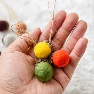 Handmade wool felt acorns with natural caps and jute loops for Christmas tree decoration