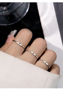 Macro shot of minimalist silver S925 ring featuring engraved zodiac symbols for women