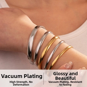 Detail of vacuum plated stainless steel oval bangles in gold and silver finish