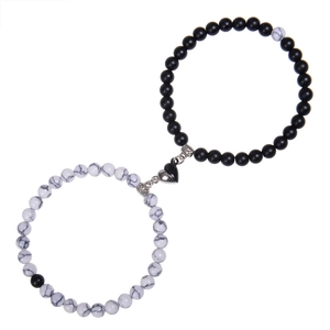 Macro detail of magnetic heart clasp on stone couple bracelets with zebra jasper beads