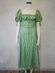 Detailed view of puff sleeves and drawstring square neck on a green floral maxi dress