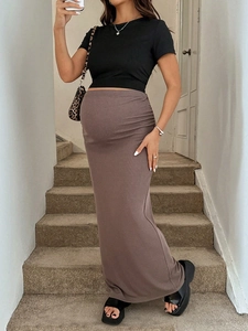 Detail of high waist maternity knit skirt in brown with adjustable elastic ribbed texture