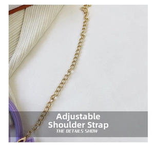 Macro detail of golden metal chain strap and spring hook on a purple fashion handbag