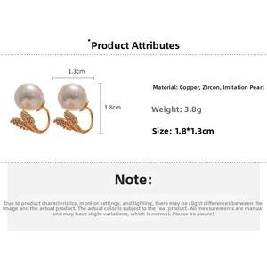 Detail view of pearl fishtail earrings with dimensions 1.8cm by 1.3cm and weight 3.8g