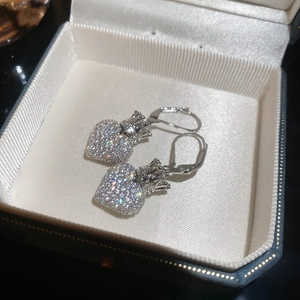 Macro detail of silver crown heart earrings with cubic zirconia in jewelry box