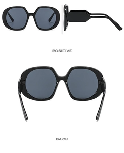 Detail view of large-frame retro sunglasses with thick temples and dark grey lenses