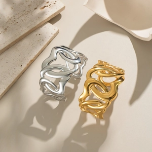 Elegant geometric hollow chain bangle in gold and silver finish on a minimalist stone base