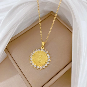 Macro shot of gold portrait medallion pendant with sparkling crystal halo on fine chain