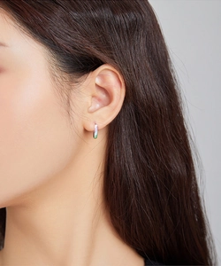 Close-up of elegant small rainbow hoop earrings worn by a model for a stylish look