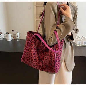 Detail of red and black leopard print tote bag with purple leather trim and large capacity