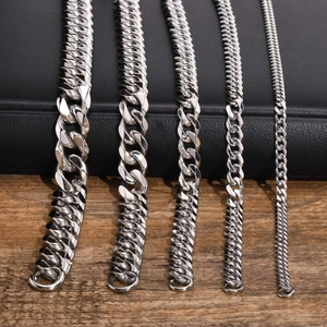 Comparison of five different widths of polished silver Cuban link chains on a textured desk