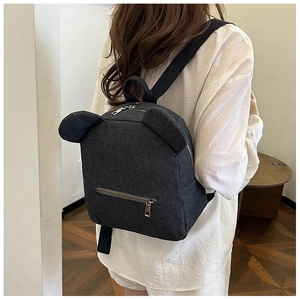 Detail of dark grey denim backpack with cute bear ears and metallic front zipper pocket
