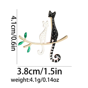 Detailed view of the 4.1cm x 3.8cm black and white cat brooch with size measurements