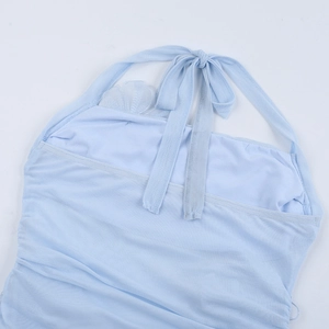 Detail of light blue mesh evening dress showing back neck tie and fabric texture