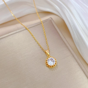 Detailed close-up of a luxury gold-plated titanium necklace with zircon on silk