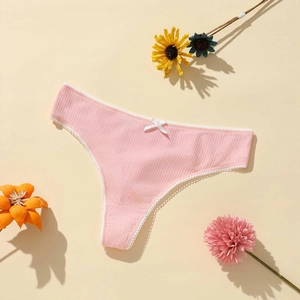 Close-up of pink ribbed polyester thong with white lace trim and bow detail