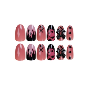 Pink and black flame press-on nails with 3D bows and skull design on white background