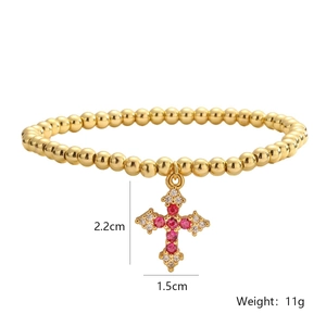 Detail view of a gold-plated cross bracelet with dimensions 2.2cm x 1.5cm and 11g weight