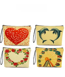 Close-up of four printed makeup bags with heart, dolphin, rose and ferris wheel motifs