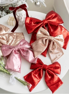 Close-up of pink and gold glitter fabric Christmas bows for tree decoration