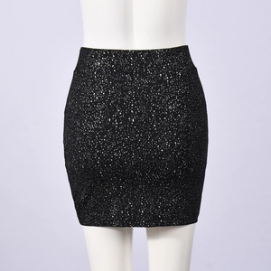 Detail showing high-waisted black mini skirt with white starburst pattern and elastic fit