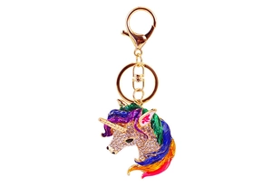 Macro detail of gold-plated unicorn keychain with crystals and rainbow enamel colors