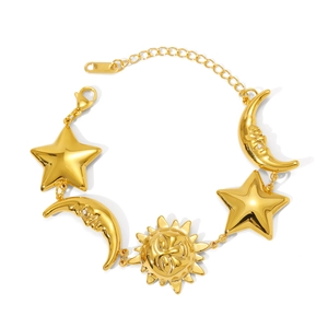 Close-up of golden bracelet featuring celestial sun, moon and star charms with lobster clasp