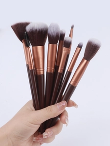 Close-up of 10-piece makeup brush set with brown handles and rose gold ferrules