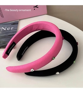 Detail of pink and black sponge headbands with colorful rhinestones and velvet texture