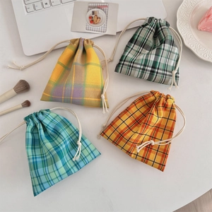 Detailed close-up of colorful checkered drawstring fabric pouches for small item storage